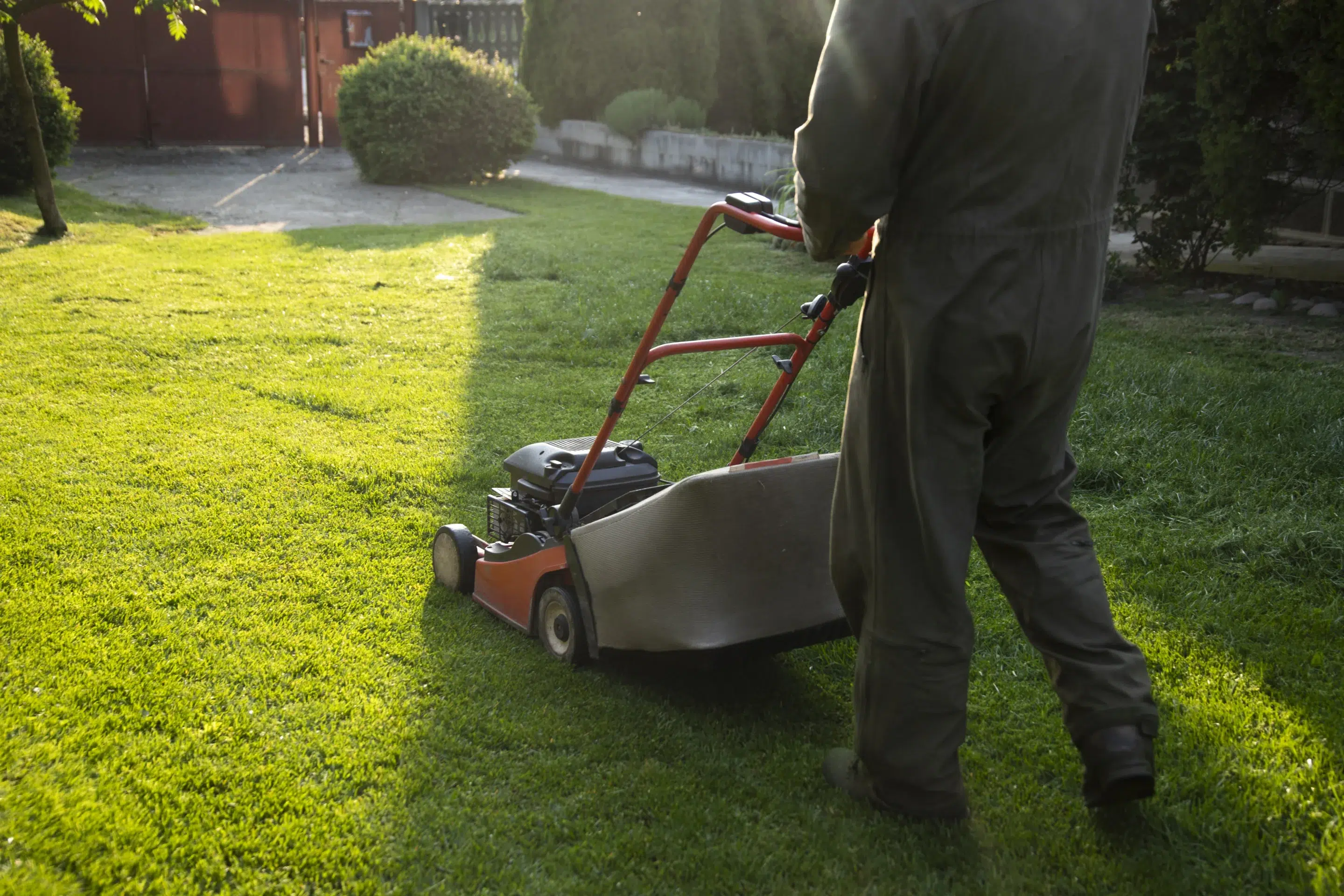 Lawn technician preparing equipment for a mowing visit